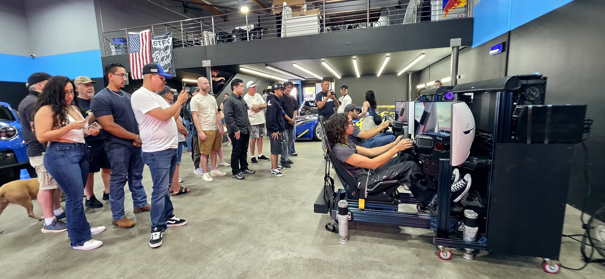 A crowd gathered around a Trackside racing activation