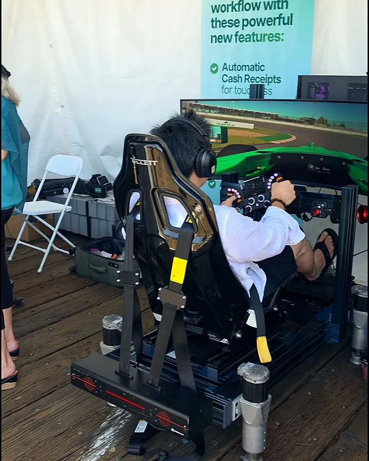 An insurance leader at the wheel of a Trackside full-motion Formula 4 simulator in the Epay Policy footprint