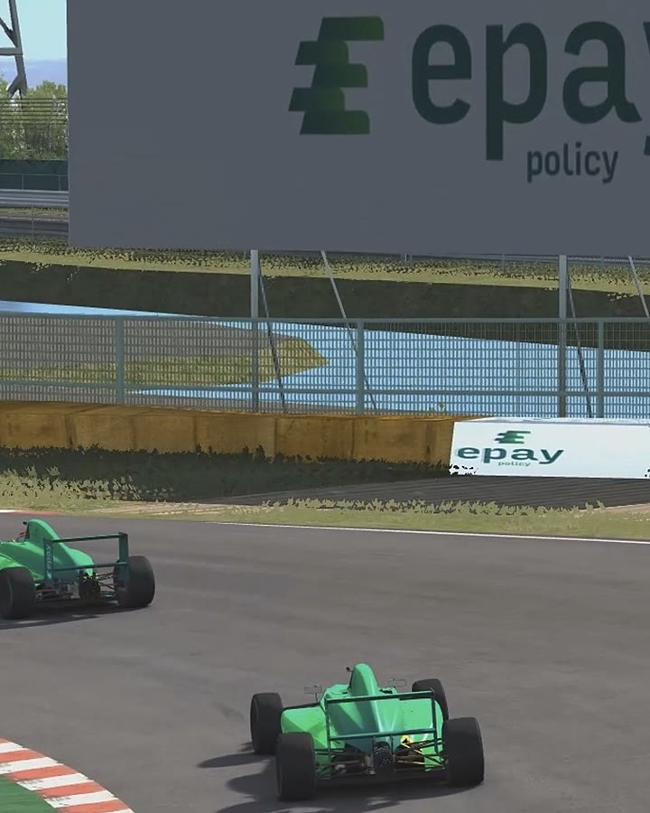 In-sim Epay Policy trackside boards as two liveried Formula 4 cars race through the corner