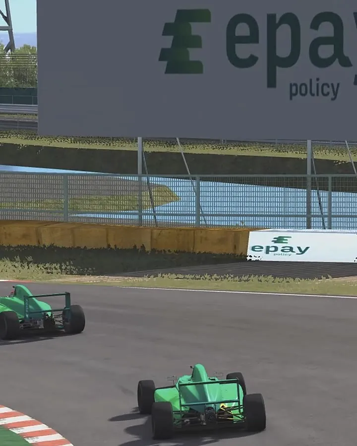 In-sim Epay Policy trackside boards as two liveried Formula 4 cars race through the corner
