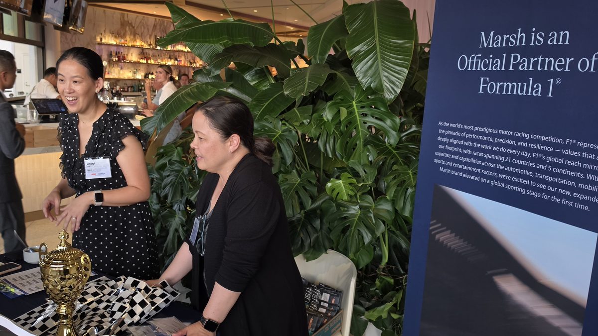 Guests gathered near the client event signage as the standings were read at the Mercer reception