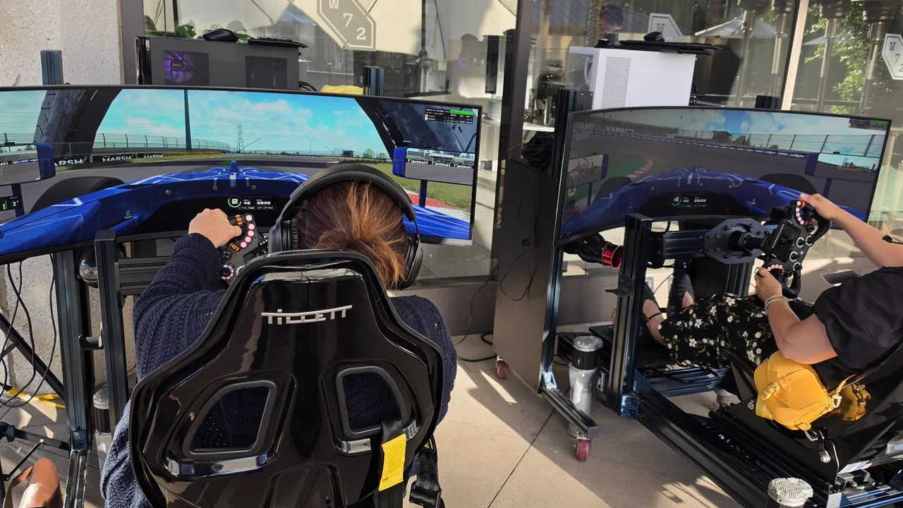Two guests driving full-motion racing simulators side by side at the Mercer reception in Irvine, California