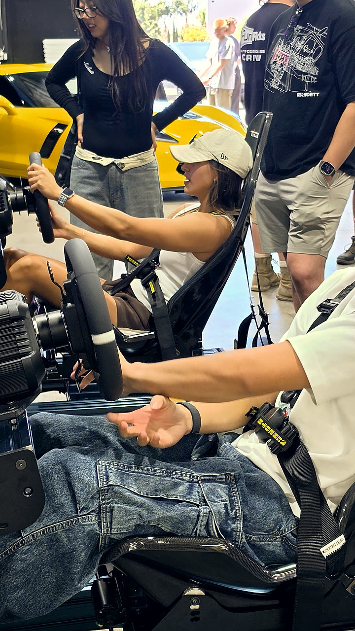 A fan at the wheel of a Trackside full-motion simulator at the NASCAR San Diego fan activation