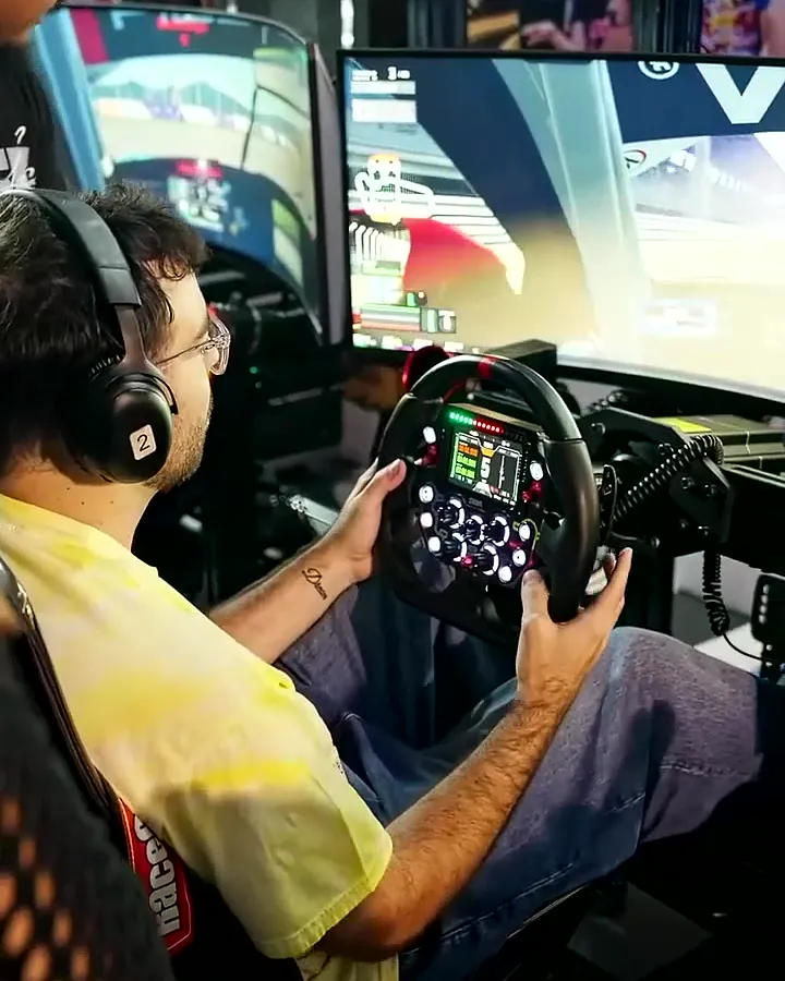 Two guests racing side by side on networked simulators at PuffCon